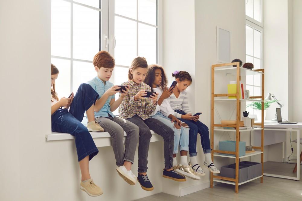 Group of children engaged with phones