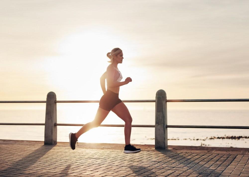 Jogger exercising near the water's edge