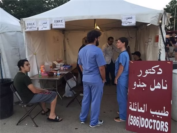 People outside a medical assistance tent