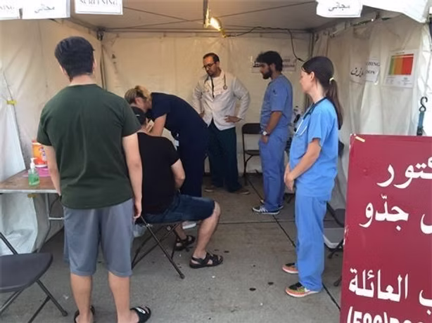 People gathered in medical outreach tent