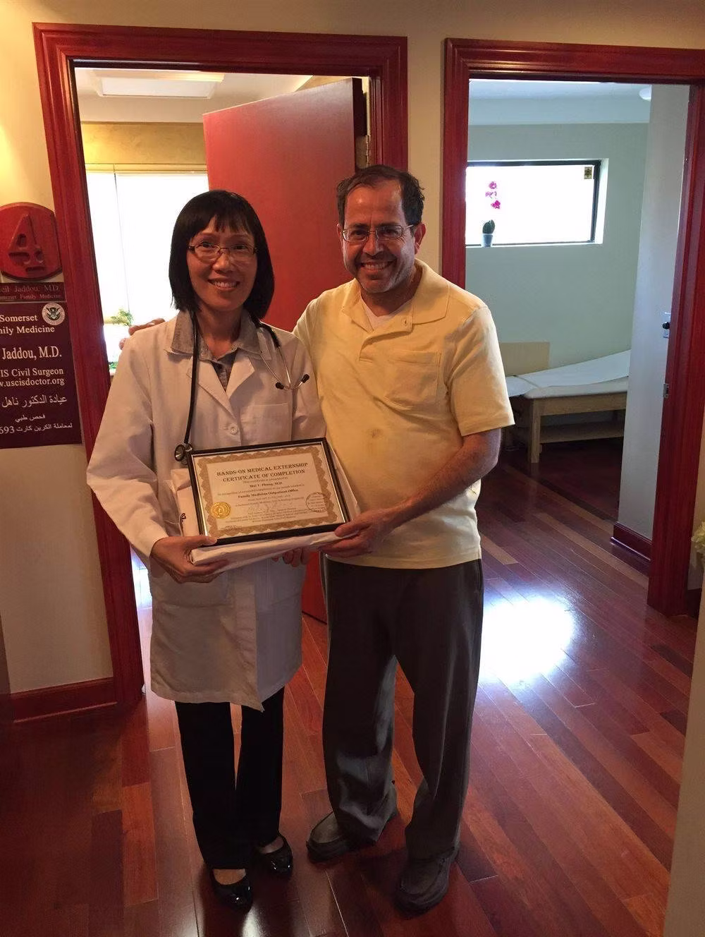Doctor holding a certificate with a man