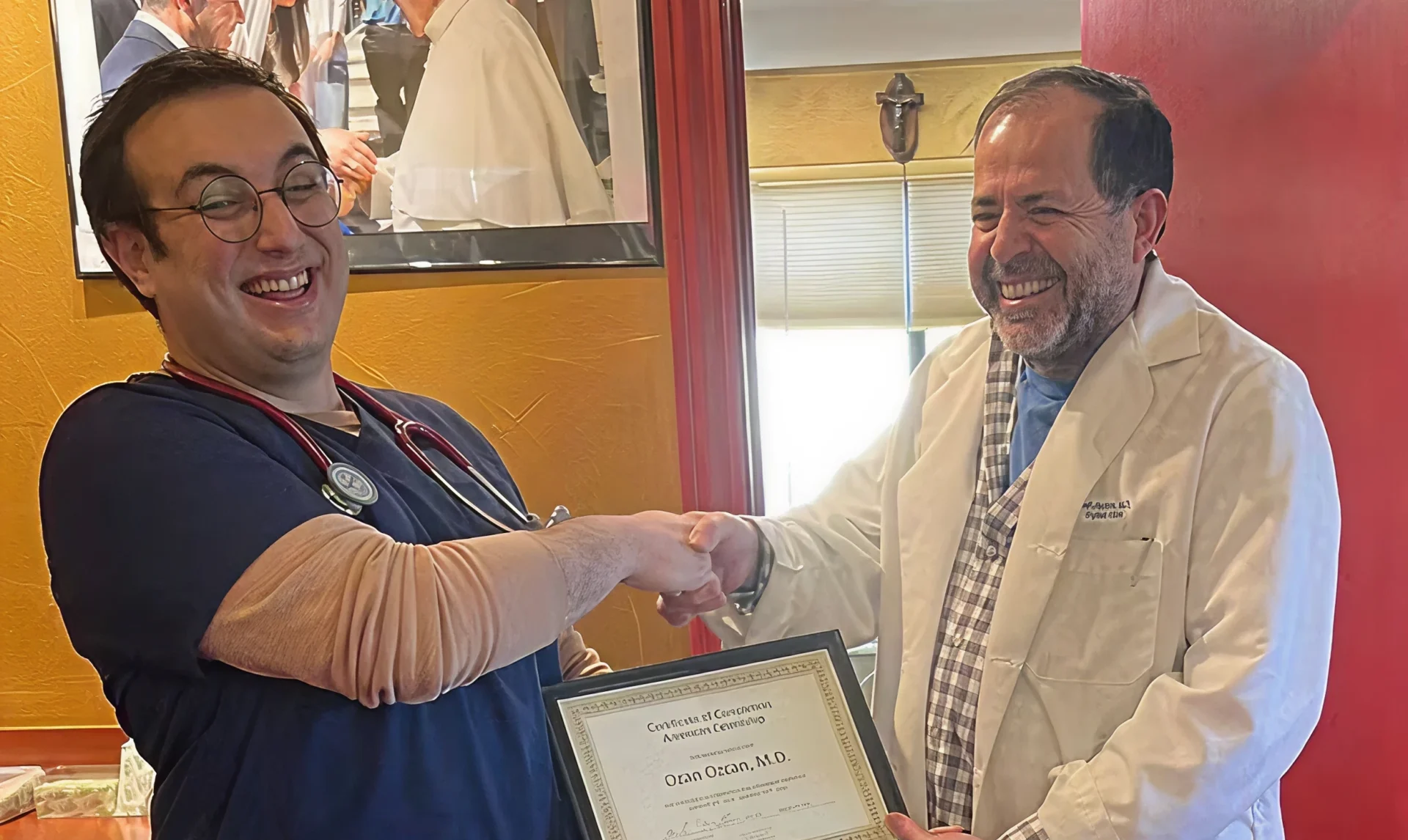 Doctors shaking hands with a certificate