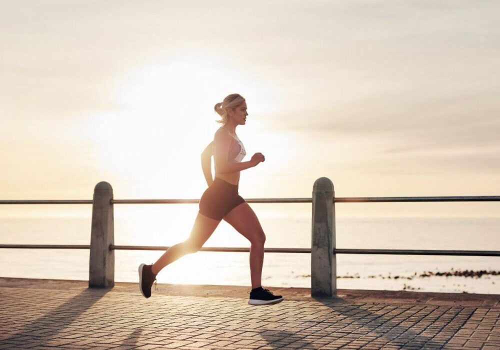 Jogger exercising near the water's edge